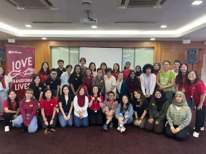 A large group of volunteers and team members from a Malaysian nonprofit gathered indoors for a group photo, smiling in a conference room setting. The image reflects community collaboration and impact, often associated with initiatives tied to donation tax Malaysia and social giving efforts.